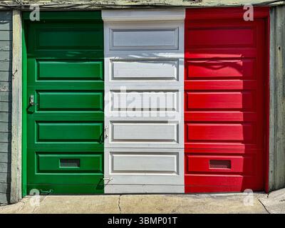Garage door painted in the colors of the Italian flag, red, white and green, in a historically Italian neighborhood. Stock Photo