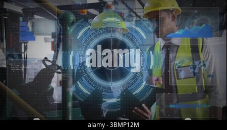 Engineers using holographic interface in plant, with tablet and yellow hard hats and vests Stock Photo
