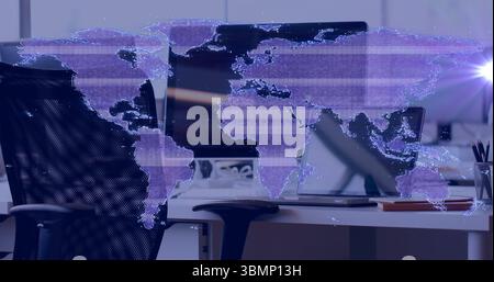 Displaying digital world map overlay across office, with flatscreen monitor, laptop, notebook Stock Photo