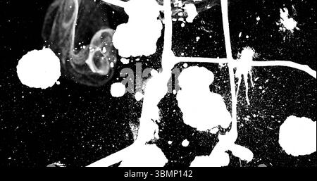 Displaying abstract white paint splatter pattern on canvas surface, featuring drips streaks blobs Stock Photo