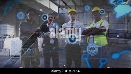 Collaborating team wearing yellow hard hats and vest studying holograms around pallets in warehouse Stock Photo