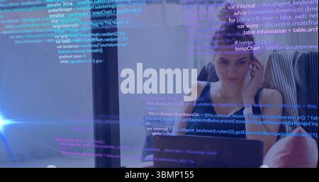Focusing coder wearing striped shirt viewing laptop at glass partition, code overlay, copy space Stock Photo