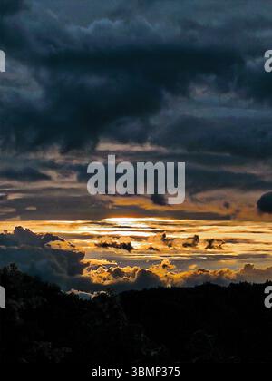 Aerial drone view of sunset with village lights Stock Photo