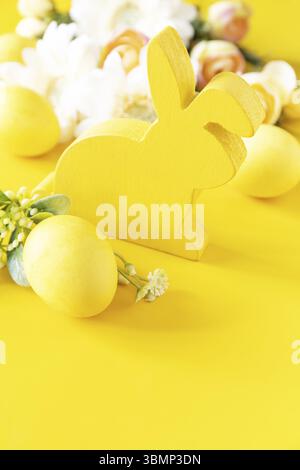 Wooden spring easter bunny figurine on grey natural background. Copy ...