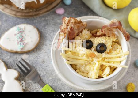 Scrambled eggs easter bunny on a stone background. Easter breakfast idea Stock Photo