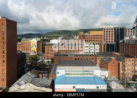Belfast city centre skyline and rooftops looking west past the Holiday Inn hotel towards the Black Hill and Black Mountain, Northern Ireland Stock Photo