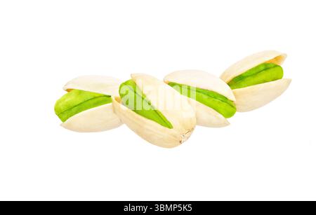 Close-up of pistachios nuts, isolated on white background. Flying pistachios, isolated on white background. Stock Photo