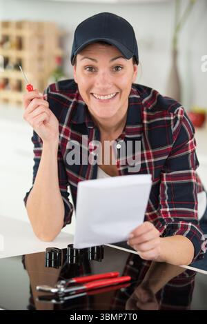 woman installing a new hob in modern kitchen Stock Photo
