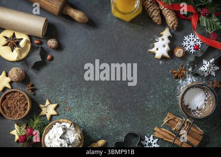 Ingredients for baking homemade sweet present Linser Christmas or New Year cookies on a table of dark stone. Top view flat background. Copy space Stock Photo