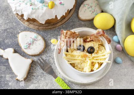 Easter breakfast idea. Scrambled eggs easter bunny on a stone background Stock Photo
