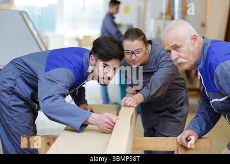 carpenter with apprentice in training period Stock Photo