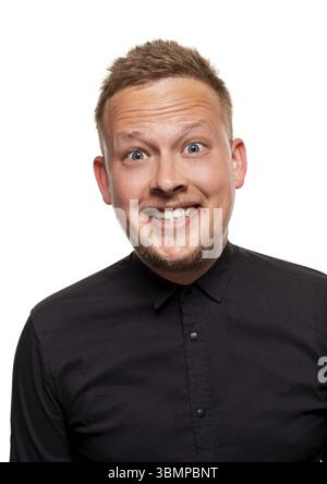 Close up portrait of a confident, blond, handsome young man wearing black shirt, smiling at the camera, isolated on white background Stock Photo