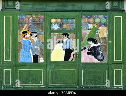 Vintage illustration of a couple buying clothes in a tailor's shop with two tailors working Stock Photo