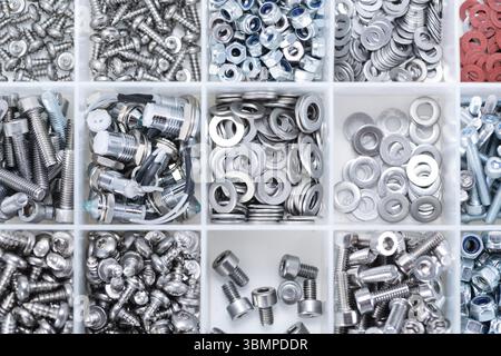 Different Screws and other Parts sorted in a box (close-up shot) Stock Photo