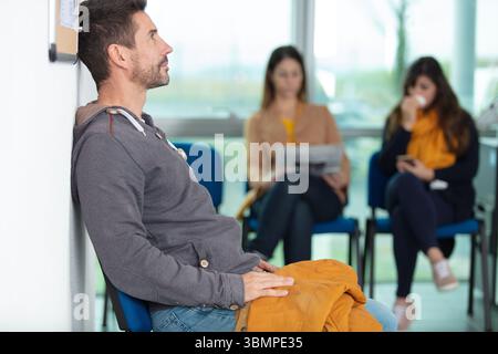 diverse people sitting waiting room Stock Photo