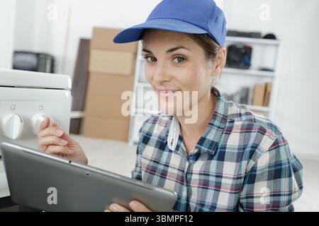 portrait of pretty young technician using tablet Stock Photo