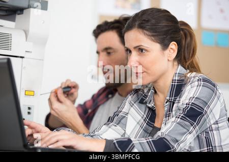 woman calibrating printer while working in nice printing office Stock Photo