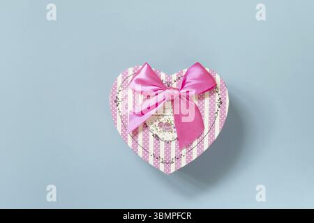 Valentine's day concept with heart gift box on a blue background, minimal layout. Top view flat lay Stock Photo