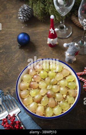 Winter Christmas salad. Delicious salad with chicken, cheese, walnuts and grapes on a festive table. Copy space Stock Photo