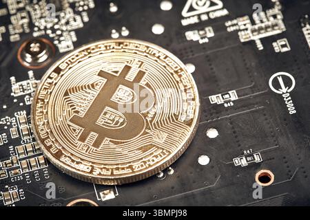 Bitcoin. New virtual money. Bitcoins lie on the video card, concept of mining. Flat lay. Top view. Still life Stock Photo