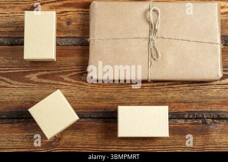 Gift Packed in eco-friendly biodegradable cardboard on dark old wooden background with blank space for text. top view. flat lay Stock Photo