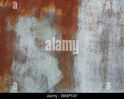 rusting metal texture with white paint strokes as abstract empty rough background, textured rusting iron sheet with place for insertion, oxidized meta Stock Photo