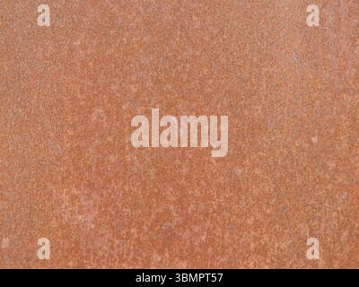 rusty iron sheet texture as empty rough relief monochromatic background, flat surface of oxidized metal copy space, rust on piece of iron Stock Photo