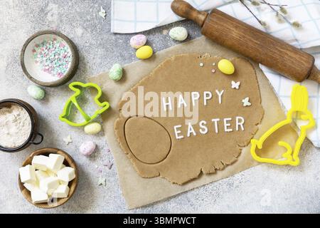 Background for baking or cooking Easter cookies. Ingredients and kitchen utensils for baking on a light stone table Stock Photo