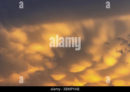 Threatening yellow clouds in a storm at sunset Stock Photo