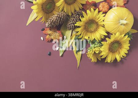 Autumn composition. Creative layout made of festive autumn decor of pumpkins, sunflowers and leaves on a brown background. Nature Trendy Decorative De Stock Photo