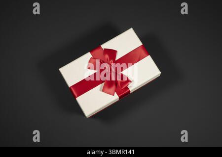 Wrapped vintage gift boxes with red ribbon bow, isolated on black Stock Photo