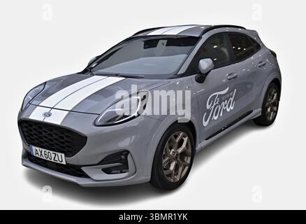 Modern gray Ford Puma with white stripes parked on a seamless white background Stock Photo
