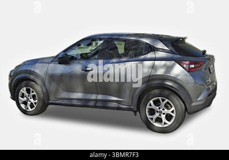 Modern gray Nissan Juke car parked on a white background, showcasing its design and features Stock Photo