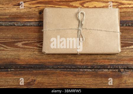 Gift Packed in eco-friendly biodegradable cardboard on dark old wooden background with blank space for text. top view. flat lay Stock Photo