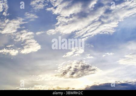 Sunset clouds with sun setting down. Beautiful evening sky with clouds background Stock Photo