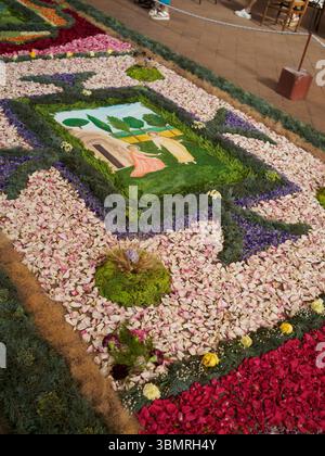Alseno, Italy June 22nd 2025 Intricate flower carpet representing biblical narrative during Corpus Domini celebration, showcasing elaborate floral art Stock Photo