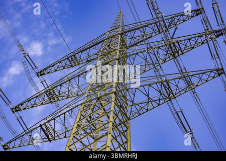 Steel structure of a tall pylon for transporting electricity over long distances seen diagonally from below Stock Photo