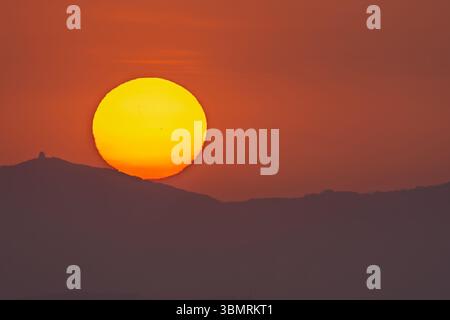 Sunset with a big sun and sunspots Stock Photo