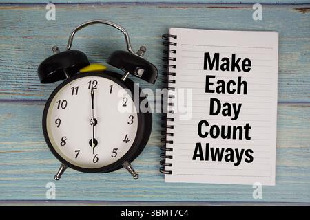 Make Each Day Count Always text written on notepad with alarm clock on wooden background Stock Photo