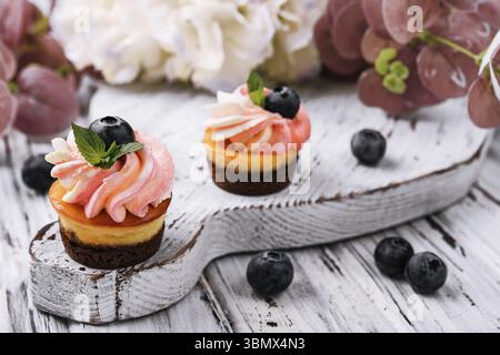 food still-life, Chocolate cupcakes with pink cream and fresh blueberry Stock Photo