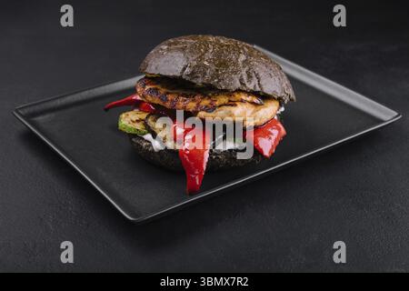 food still-life, Fresh tasty chicken burger on a black tray Stock Photo