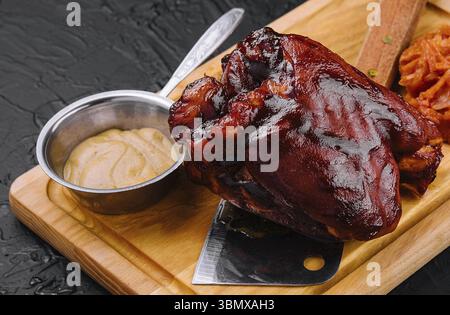 food still-life, Tasty baked pork knuckle on wooden board Stock Photo