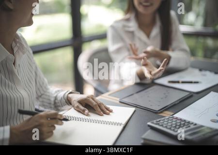 Confident young asian business woman working on laptop. Creative female executives meeting in modern startup office Stock Photo