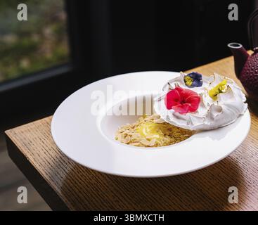 food still-life, Meringue on plate and almonds with vanilla custard Stock Photo