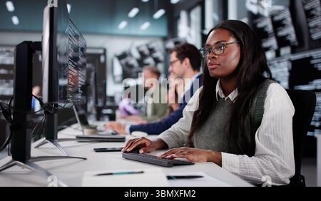 Young African American Coder Explaining New Software Development To Diverse Group. Stock Photo