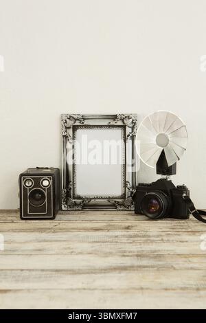 Photo frame, speaker and camera on table Stock Photo