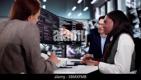 Innovative African Programmer Collaborating With Diverse Team In Cyber Office. Stock Photo