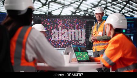 Tech Professor Leading Multiracial Engineer Team In Big Data Instruction Stock Photo