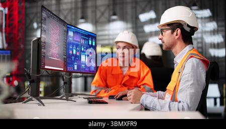Young African American Engineer Using SCADA Software On Desktop Computer Stock Photo