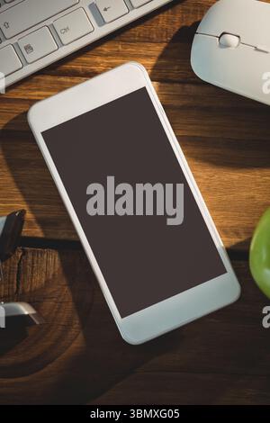Flat design is featuring smartphone on wooden desk with keyboard, mouse, green apple, lens cap Stock Photo